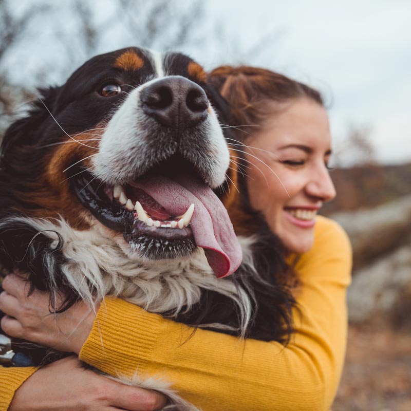 woman hugging dog